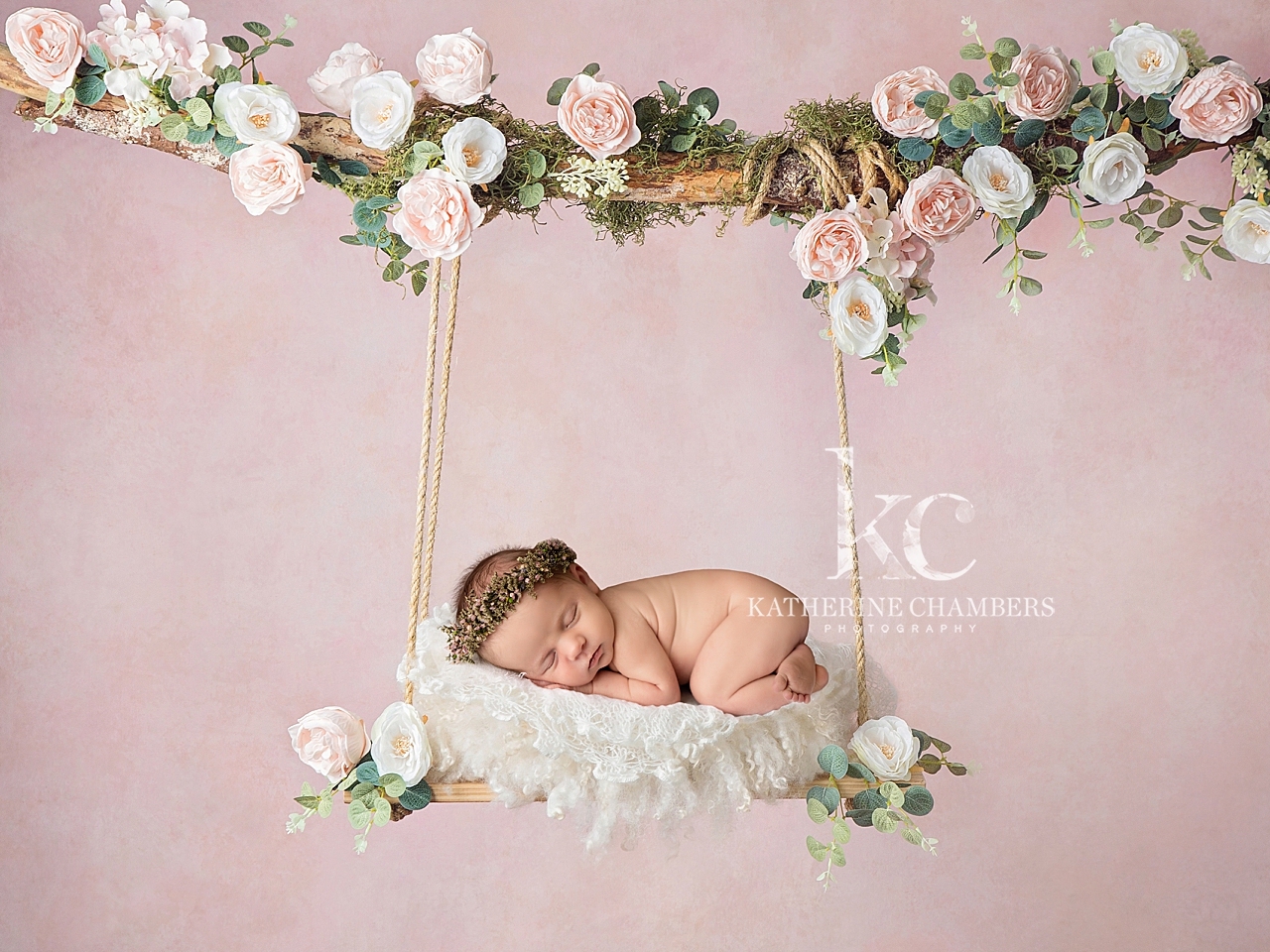 Newborn on floral swing